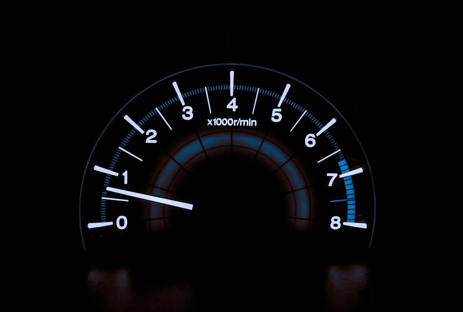 white and blue analog tachometer gauge